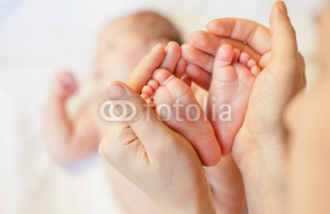Mother-holding-baby-feet-at-hands.jpg